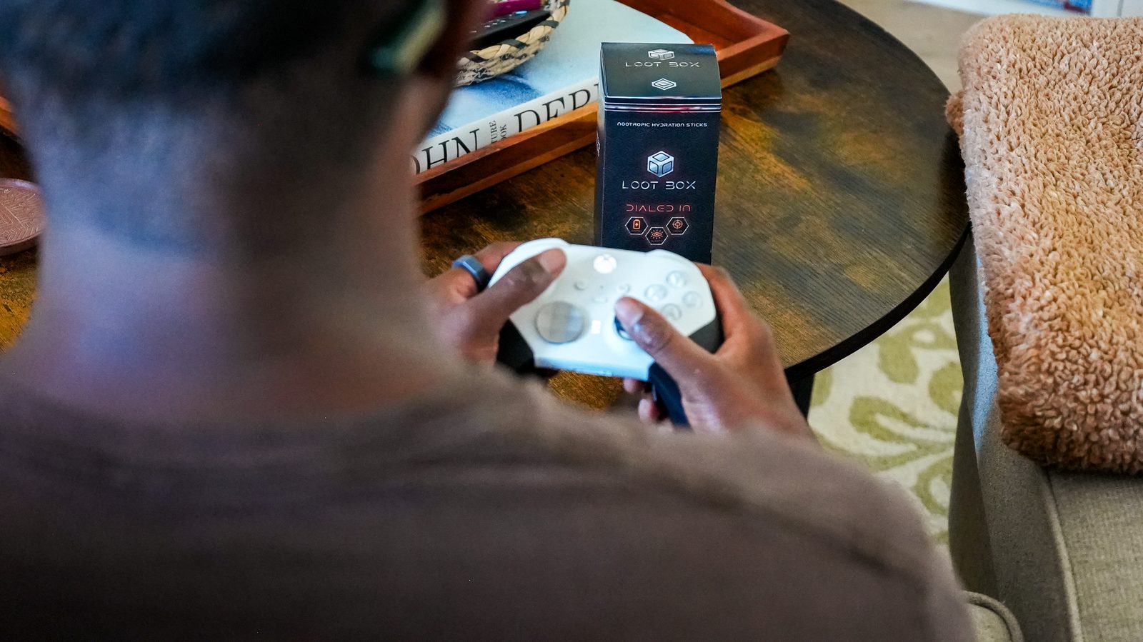 Gamer at a dark desk mid-session with Dialed In nearby